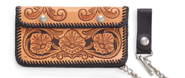 Handcrafted leather wallet with floral patterns and chain on a white background