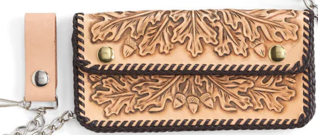 Leather wallet with leaf pattern and keychain on a white background