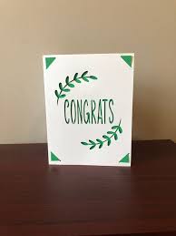 White card with green text and border on a wooden surface