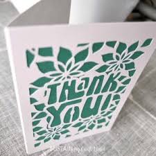 Card with 'Thank You' text and floral design on a gray surface