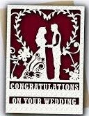 Decorative card with cut-out silhouettes of a couple and floral elements, featuring the text 'Congratulations on your wedding'.
